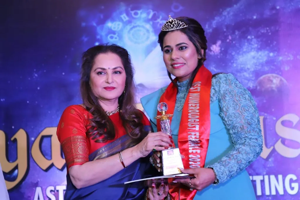 Dr. Neetti Katyal with a guest holding a plaque.