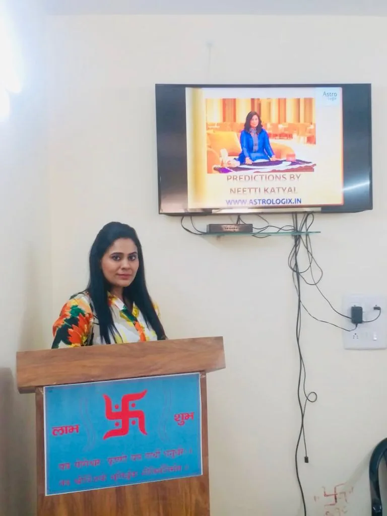 Dr. Neetti Katyal beside an indoor display.