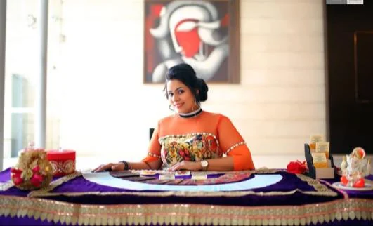 Dr. Neetti Katyal seated at her tarot reading table.